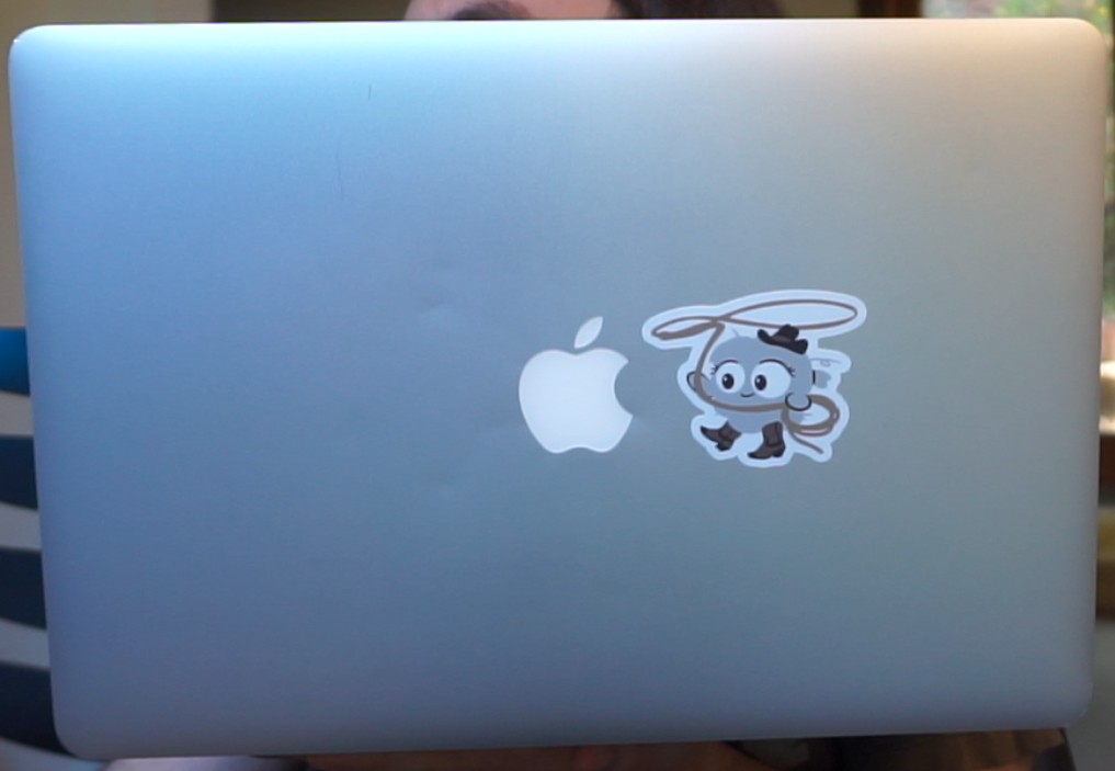 Laptop with a sticker showing Dusty, the quick-lint-js mascot